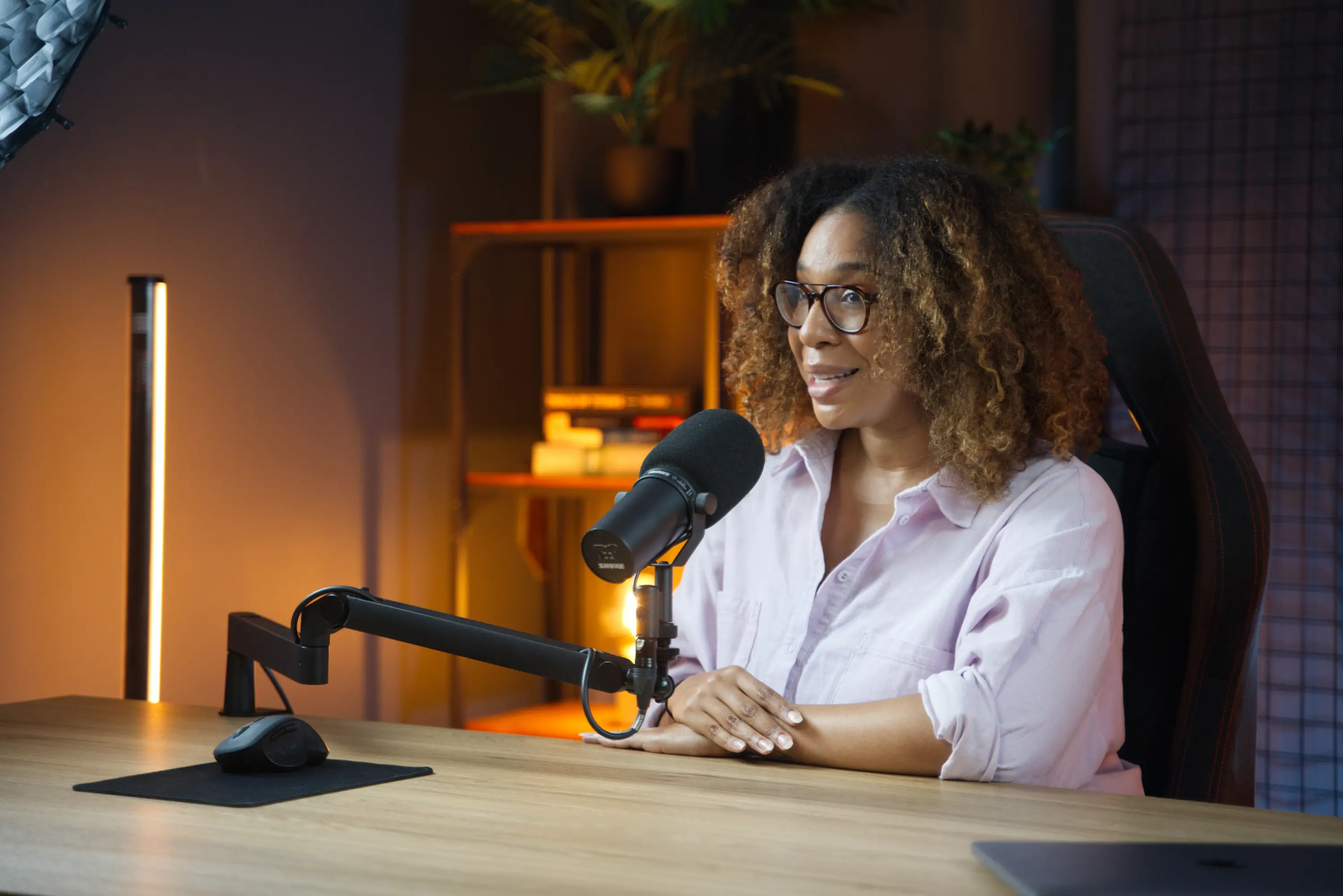 Danni Roseman, host of the Content Optimization Masterclass, at a podcast microphone